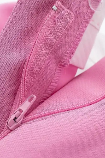 Open pink zipper on fabric of elegant casual blazer suit, short small blazer style