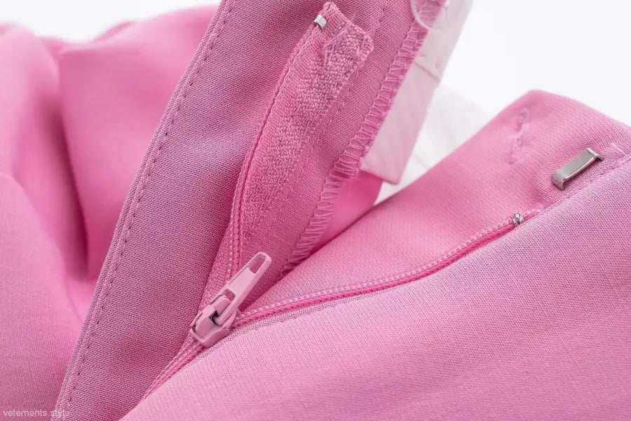 Open pink zipper on fabric of elegant casual blazer suit, short small blazer style