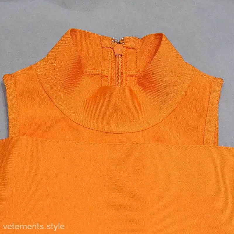 Bright orange sleeveless turtleneck top with zipper detail, suitable for shoulder evening dress
