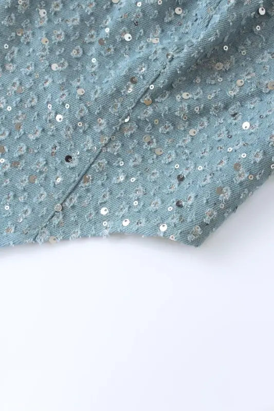 Light blue sequined fabric with seam, ideal for elegant denim and wide leg pants style