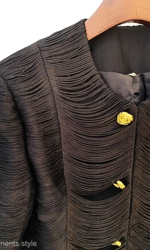 Elegant slim cotton blend tassel short jacket with textured black fabric and yellow rose buttons on wooden hanger