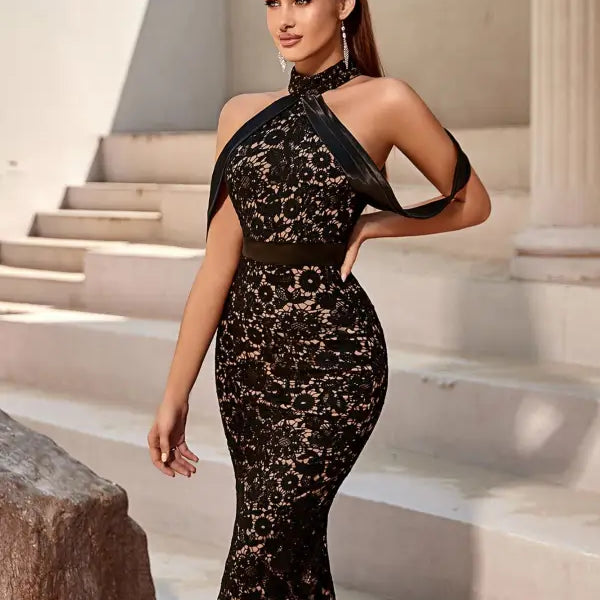 Elegant slim dress featuring black lace, halter-neck design, and knee-length hem