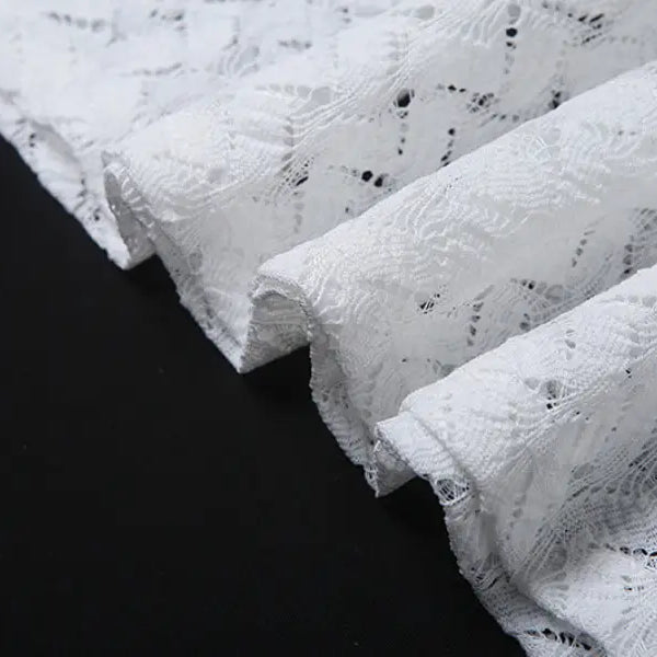 Delicate white lace fabric on an elegant slim fit evening dress with backless V-neck design