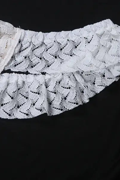 White lace garment with ruffles from an elegant slim fit evening dress collection