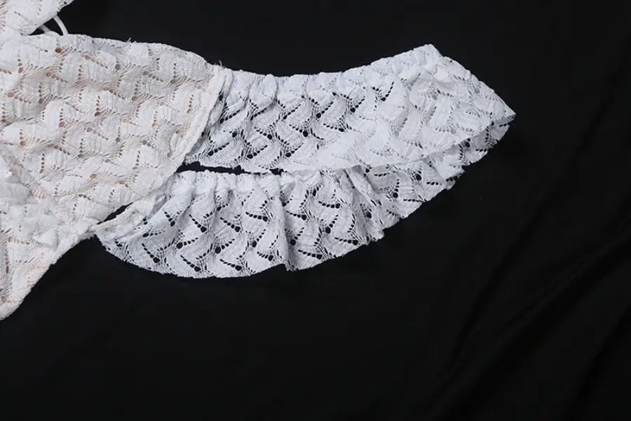 White lace garment with ruffles from an elegant slim fit evening dress collection