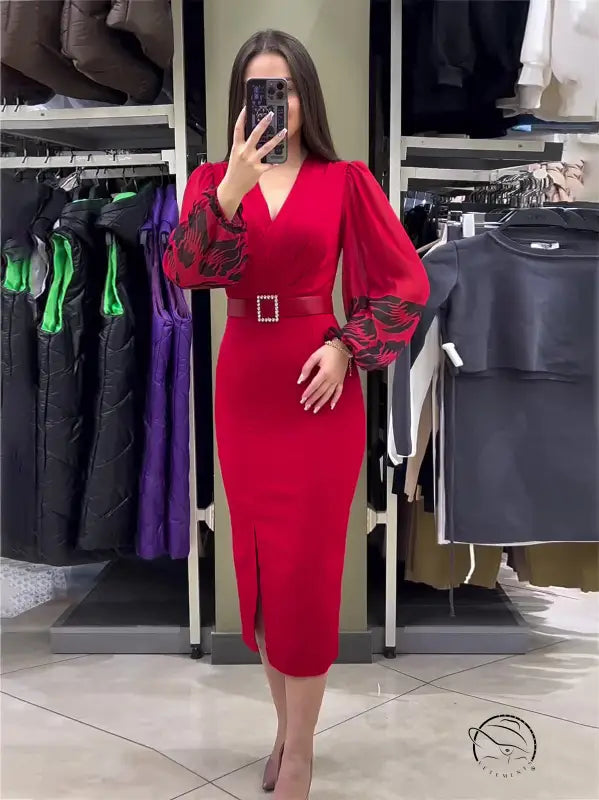 Vibrant red dress with puffed sleeves, a belted waist, and a side slit.