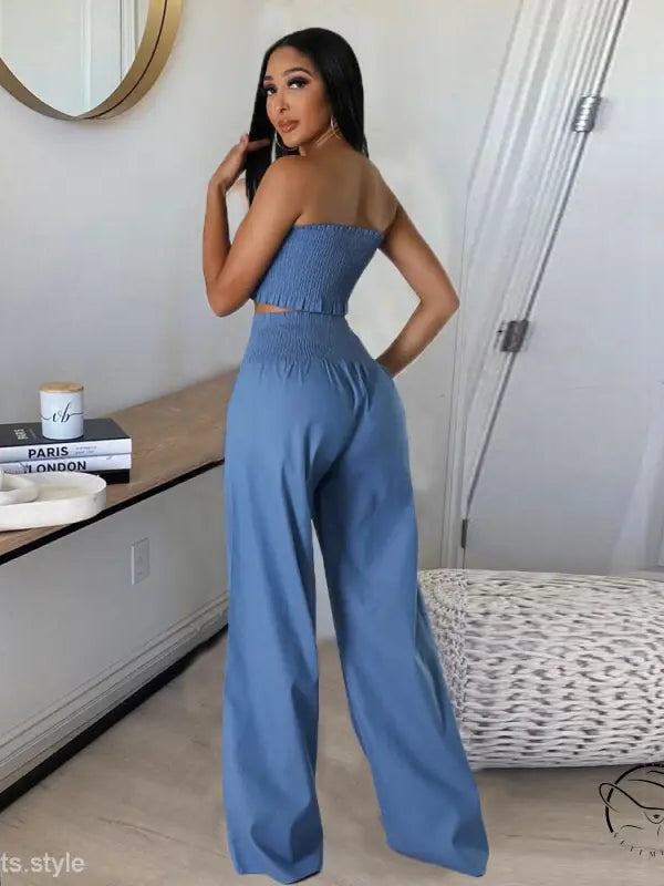 Woman in sexy slim pants suit with ruffle and smocked strapless design