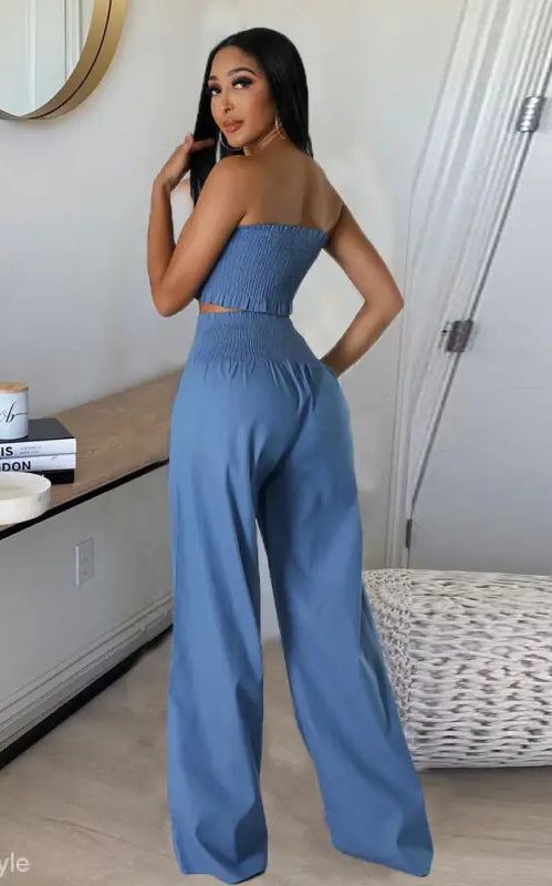 Woman in a blue sexy slim pants suit with ruffle and smocked strapless design