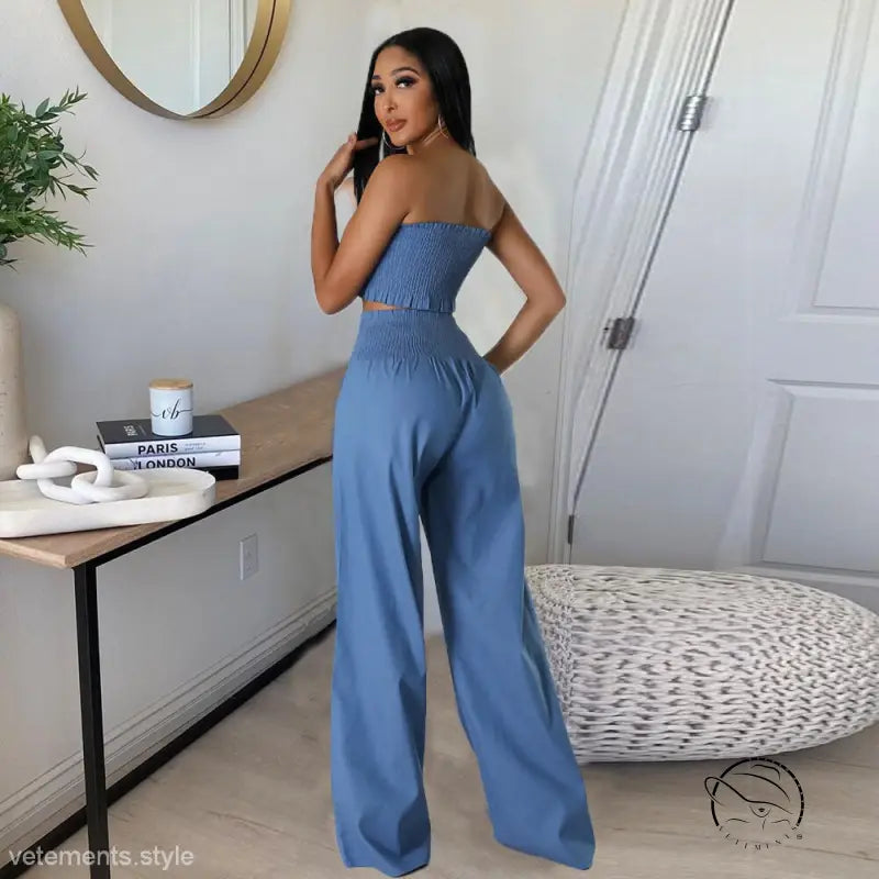 Woman in sexy slim pants suit with ruffle and smocked strapless design
