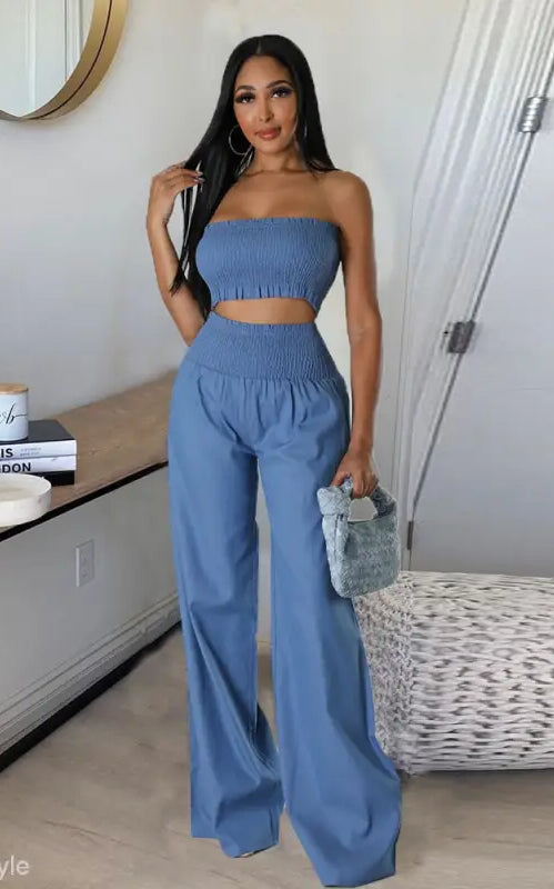 Woman in a blue sexy slim pants suit with ruffle and smocked strapless design