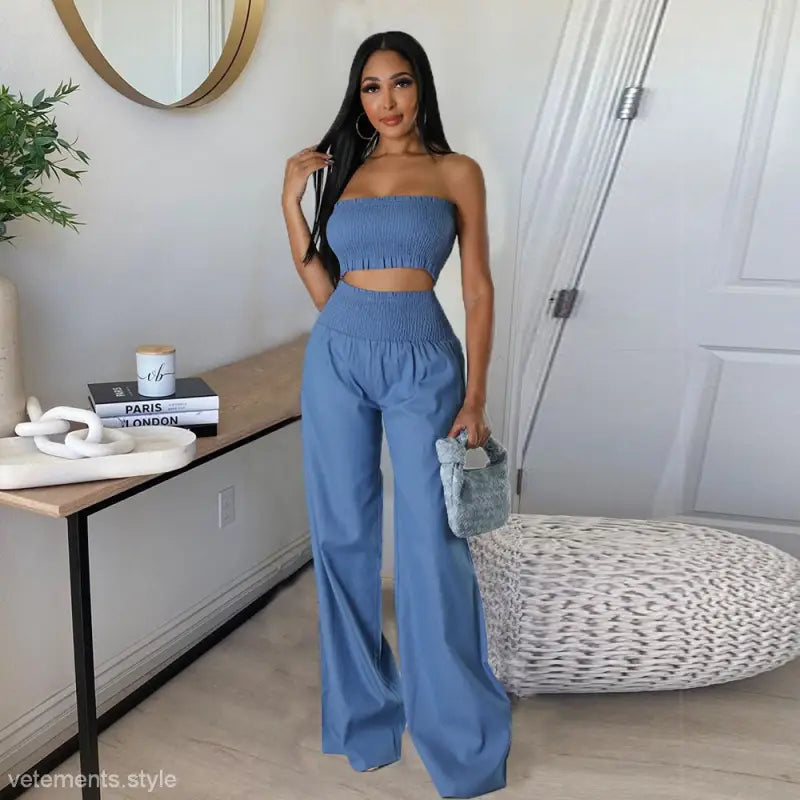 Woman in a blue sexy slim pants suit with ruffle and smocked strapless design