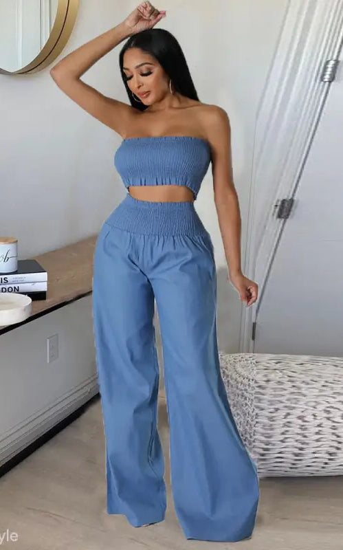 Elegant slim pants suit with ruffle and smocked strapless design worn by woman