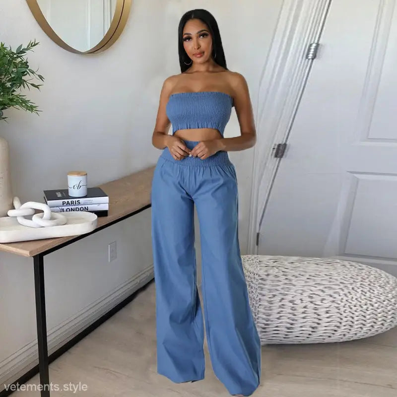 Woman showcasing elegant slim pants suit with ruffle and smocked strapless design