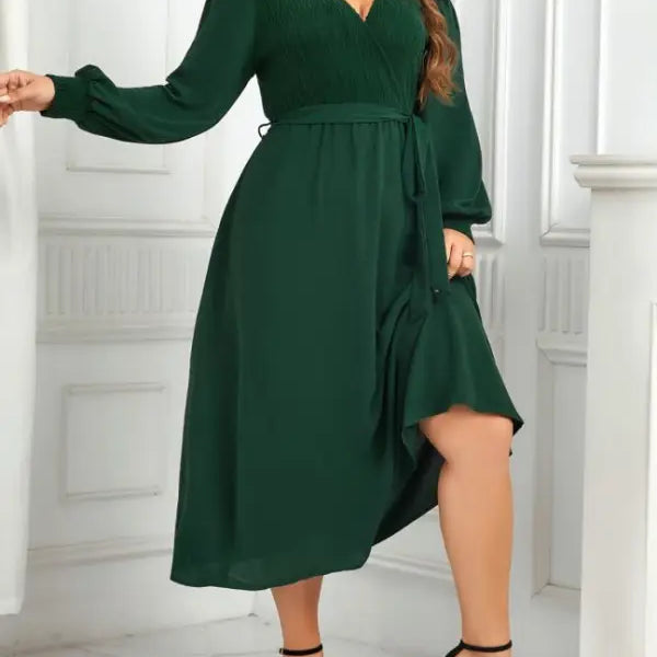 Emerald green wrap dress showcasing an elegant slimming evening dress with belted V-neck