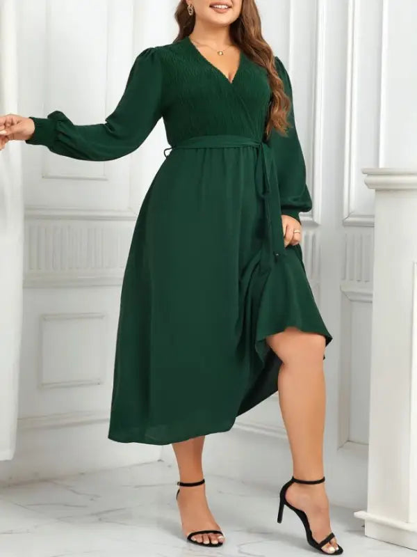 Emerald green wrap dress showcasing an elegant slimming evening dress with belted V-neck