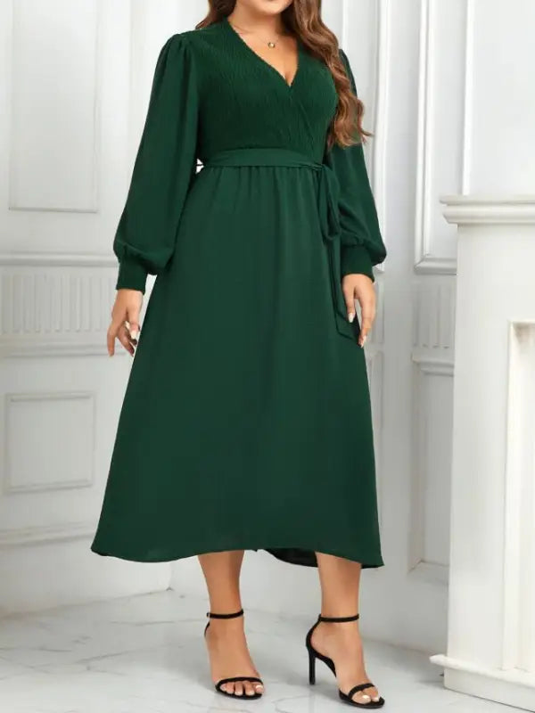Emerald green elegant slimming evening dress with belted V-neck and long sleeves