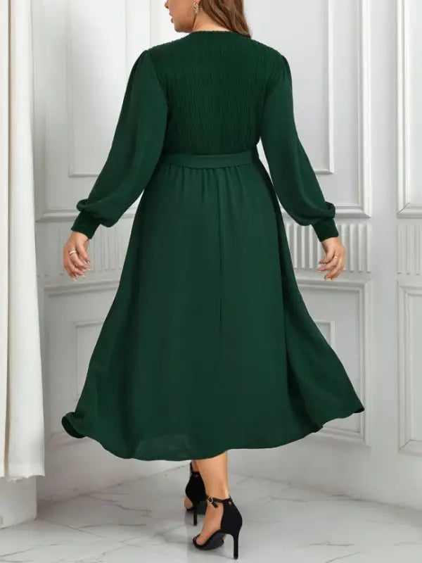 Emerald green elegant slimming evening dress with belted V-neck and long sleeves