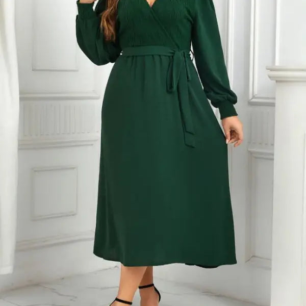 Emerald green midi dress showcasing an elegant slimming evening dress with belted V-neck