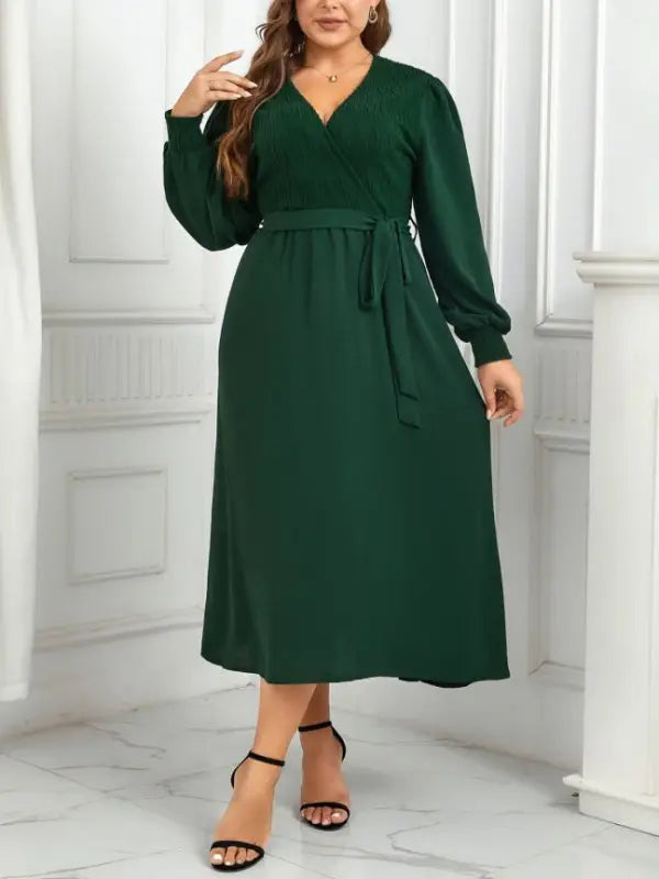 Emerald green midi dress showcasing an elegant slimming evening dress with belted V-neck