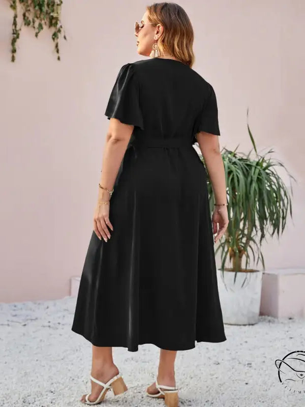 Woman in elegant slit lace slim dress with ruffles and butterfly sleeves