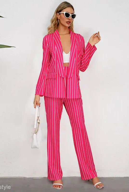 Bright pink striped blazer suit with wide leg pants and a white crop top for office wear