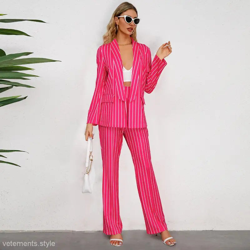 Bright pink striped blazer suit with wide leg pants and a white crop top for office wear