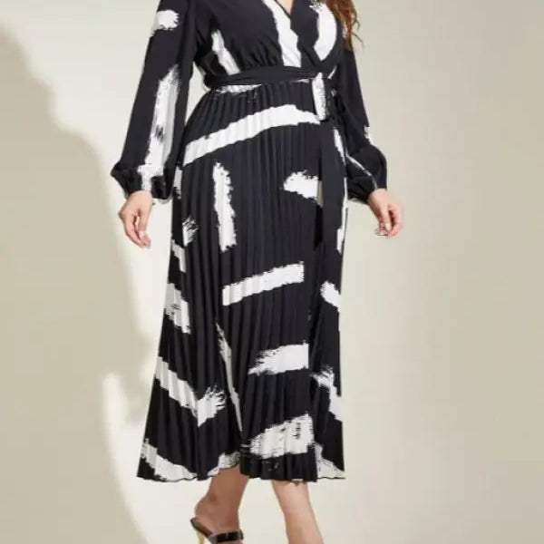 Elegant Tala Dress with belted V-neck, featuring a long-sleeved black and white pattern