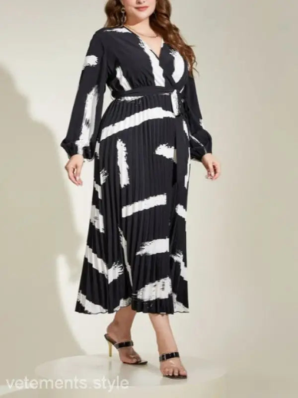 Elegant Tala Dress with belted V-neck, featuring a long-sleeved black and white pattern