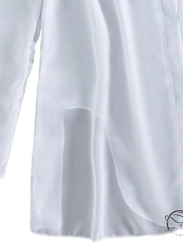 Elegant three piece sexy bikini with white flowing slit fabric on wood