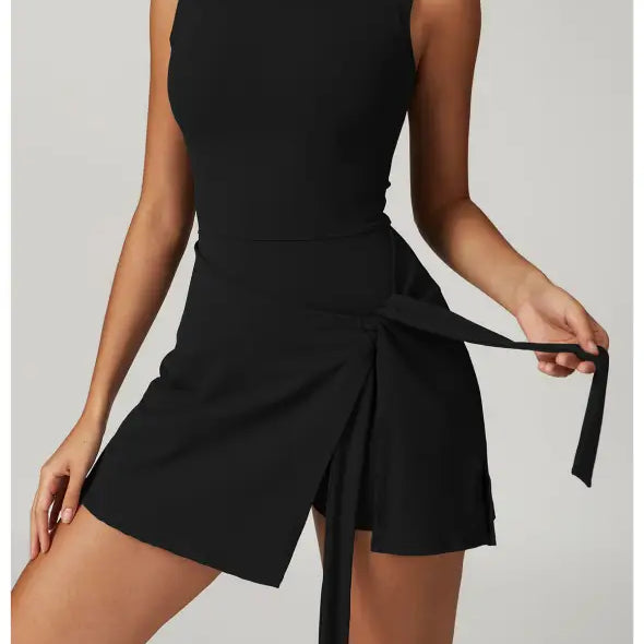 Sleeveless black mini dress with a wrap-style skirt and tie detail.
