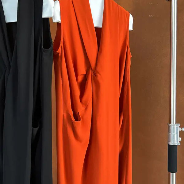 Bright orange sleeveless dress or long vest with a draped front.