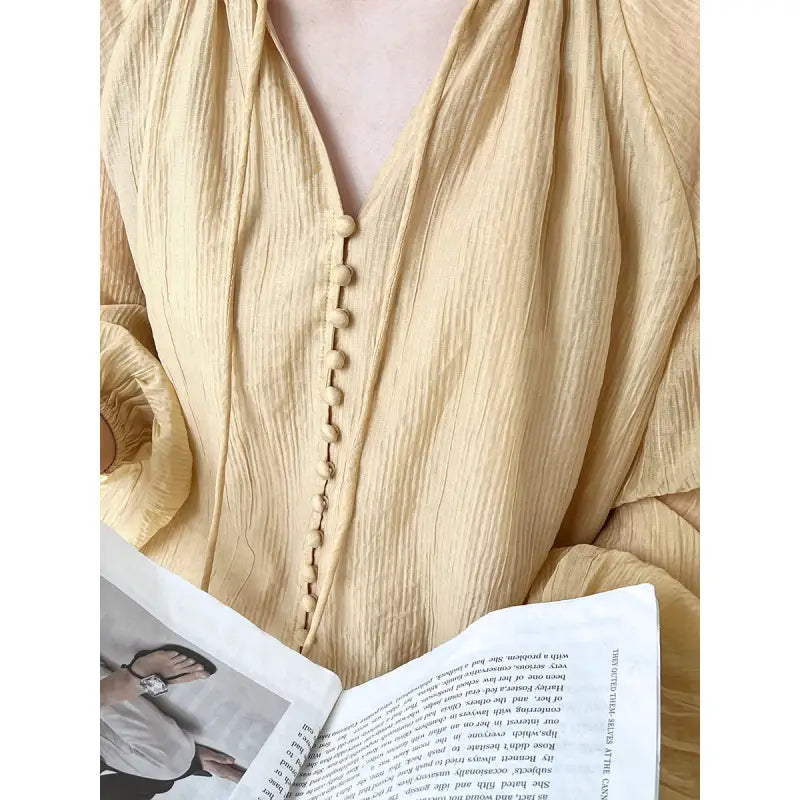 Textured yellow blouse with button detail for versatile wear with wide leg shorts
