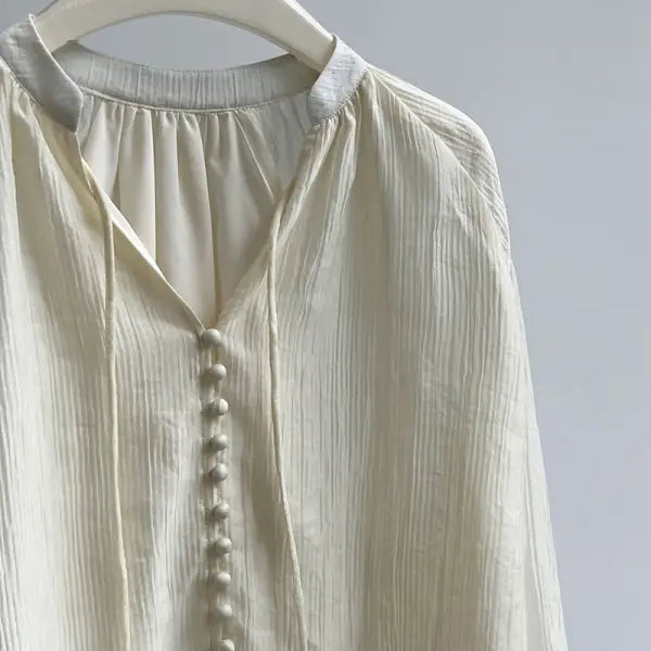 Cream-colored button-down blouse, perfect comfy shirt for versatile wear with wide leg shorts