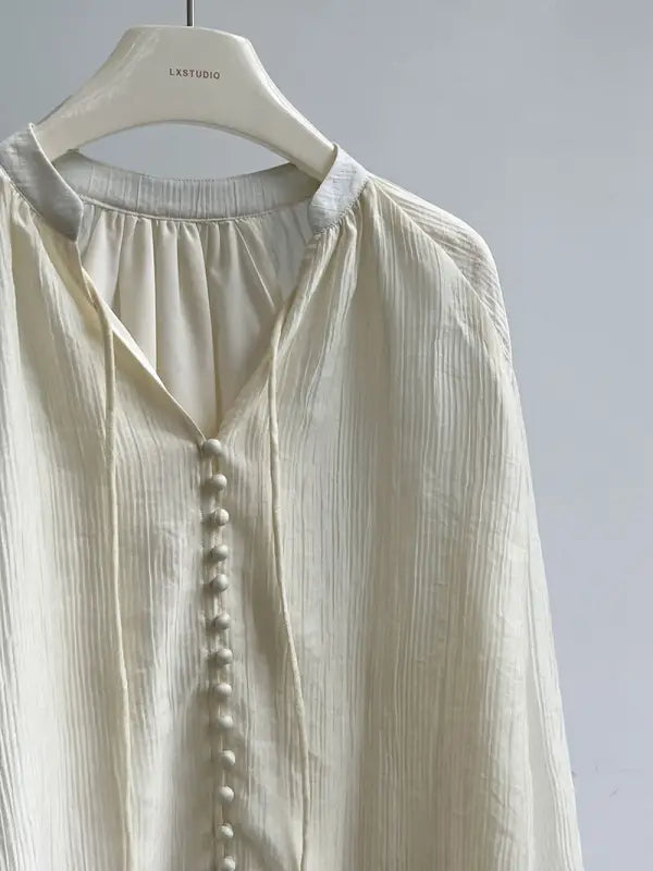 Cream-colored button-down blouse, perfect comfy shirt for versatile wear with wide leg shorts