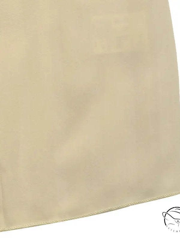 Cream fabric panel with curved edge in vacation halter pleated dress