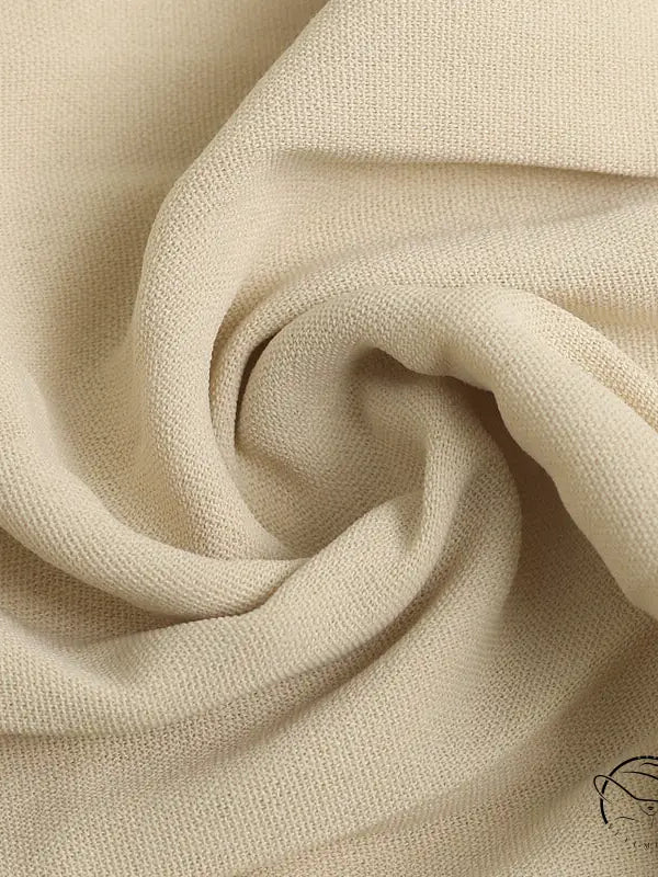 Cream-colored spiral-folded fabric in vacation halter pleated dress