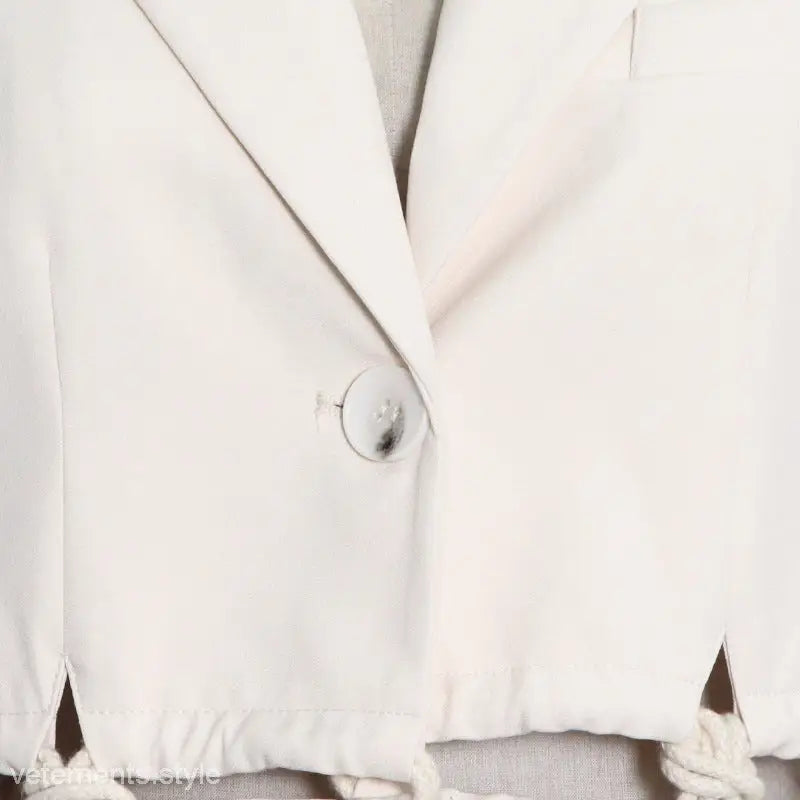 Elegant white simple blazer with single button closure and pocket detail, sold online