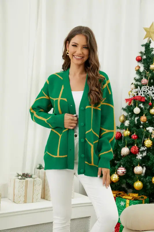 Emerald green cardigan with contrast color pattern over white outfit, stylish knitted Christmas sweater alternative