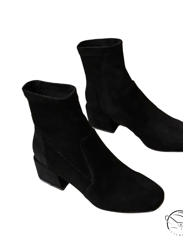 Pair of black suede ankle boots with low block heels and black velvet trim