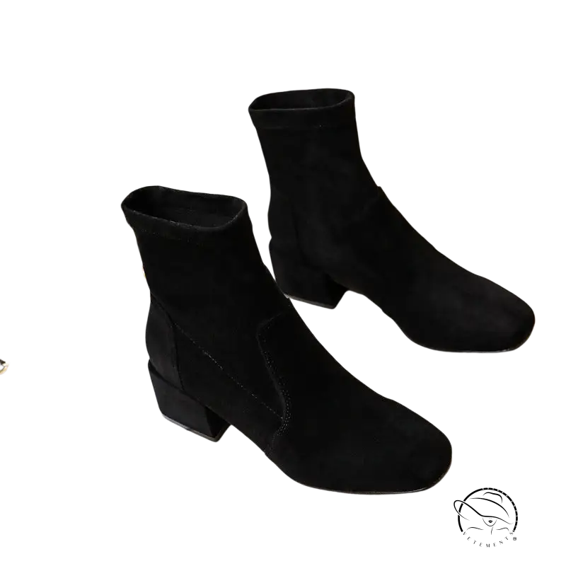 Pair of black suede ankle boots with low block heels and suede sole