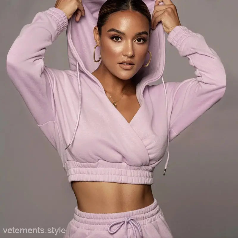 Woman in a fashionable sweater suit with open v trousers and fitted matching sweatpants