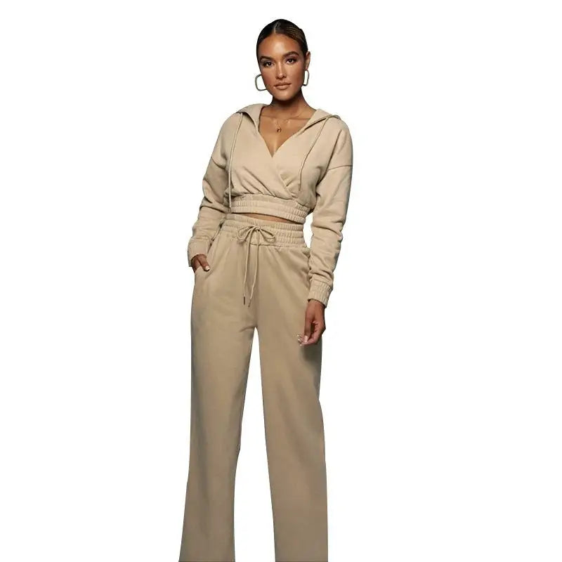 Woman in a fashionable sweater suit with open v trousers and fitted wide-leg pants