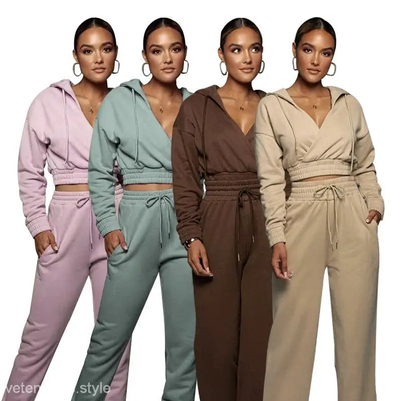 Four women wearing pastel fashionable sweater suits with open v trousers for spring and fall