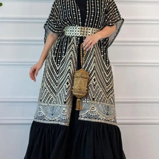 Elegant black and white patterned kaftan-style dress with gold belt and matching handbag for fashionable urban casual style
