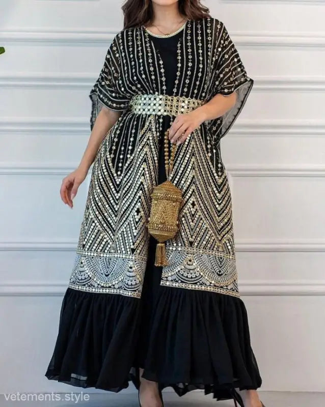 Elegant black and white patterned kaftan-style dress with gold belt and matching handbag for fashionable urban casual style