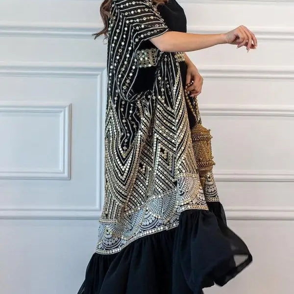 Ornate black and gold embroidered kaftan over long black dress, perfect for fashionable urban casual style