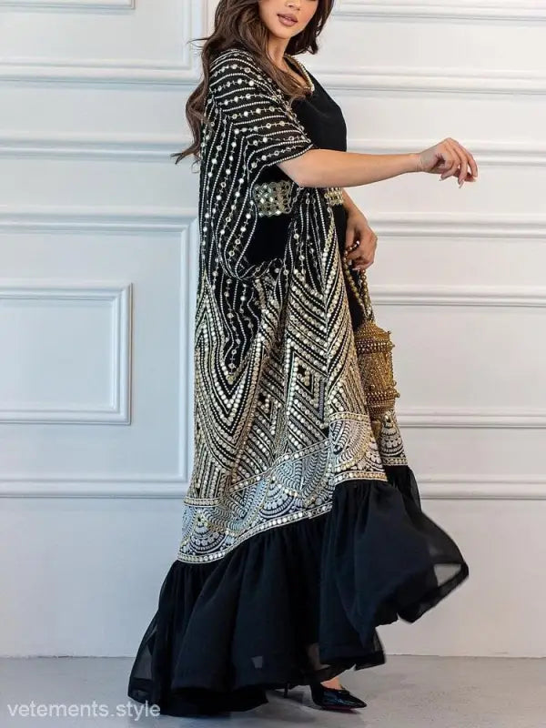 Ornate black and gold embroidered kaftan over long black dress, perfect for fashionable urban casual style