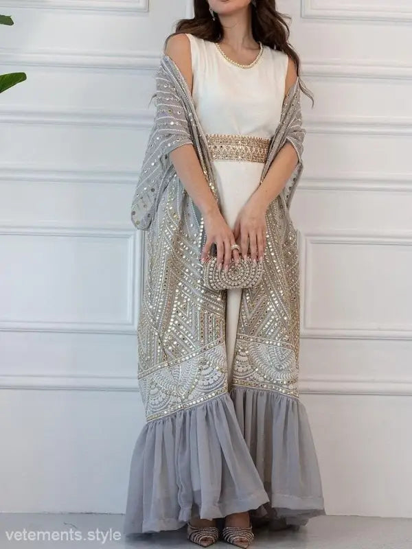 Elegant fashionable urban casual maxi dress with white bodice and intricate beadwork