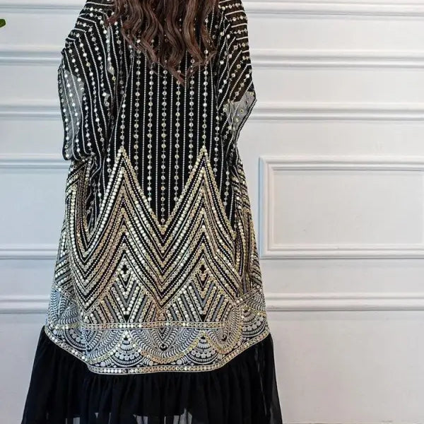 Fashionable urban casual sequined kimono-style jacket over black skirt for casual pleated look