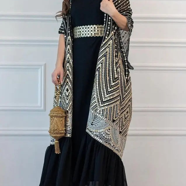 Elegant black abaya dress with geometric cardigan and gold belt for fashionable urban casual style